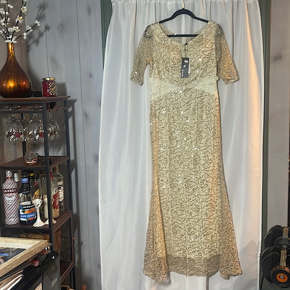 New with tags cream evening gown with champagne gold sequined overlay lace.